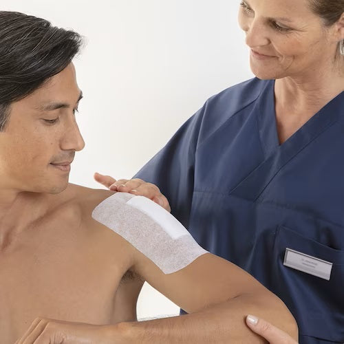 Produktbild von Fixomull Stretch, einer elastischen Wundauflage in der Größe 10 m. Die Rolle ist auf einem weißen, neutralen Hintergrund platziert und zeigt die Verpackung in einem klaren, professionellen Design. Die Folie ist in einem modernen, eher minimalistischen Stil gestaltet, mit dem Markennamen "BSN Medical" und den Produktinformationen in gut lesbarer Schrift. Die Farbgebung ist angenehm und erzeugt einen Eindruck von Funktionalität und Qualität.