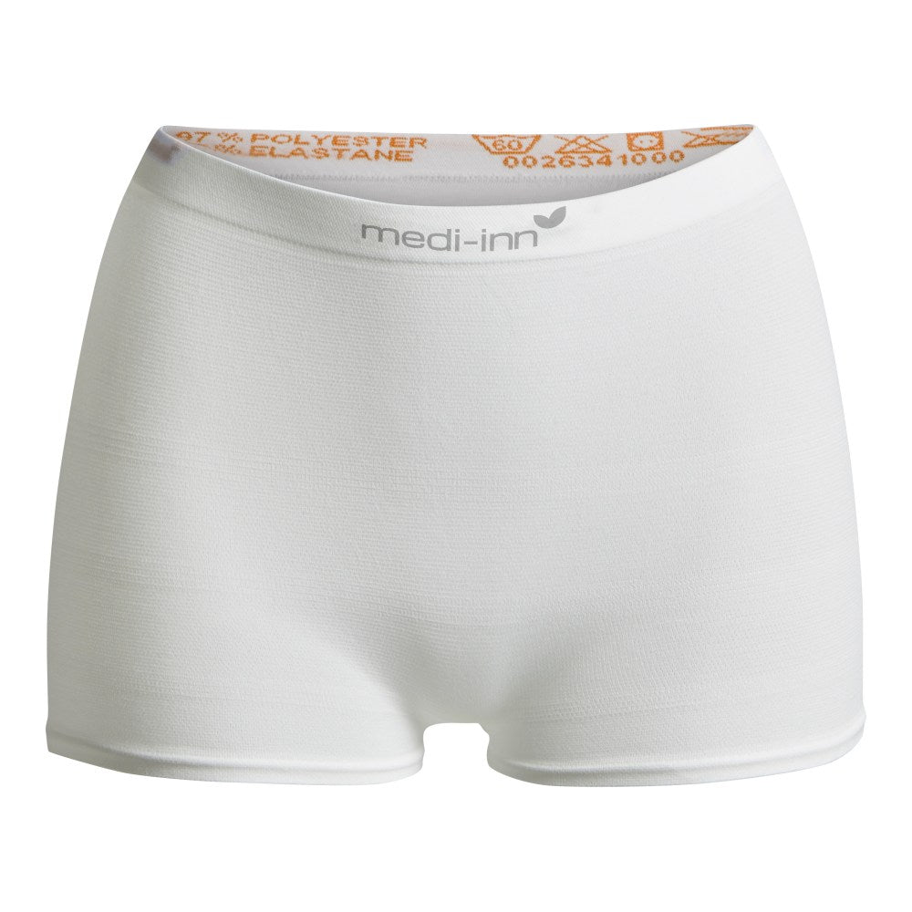 Weißes Hintergrundbild mit einem Paar schwarzer Fixierhosen aus weichem Material, die auf einer glatten Oberfläche liegen. Die Hosen zeichnen sich durch einen elastischen Bund und verstärkte Nähte aus, was ihre Stabilität und den Komfort betont. Die Hosen haben eine moderne Passform und sind ideal für medizinische Anwendungen oder als bequeme Alltagskleidung. Die Details der Stoffstruktur sind klar sichtbar, ebenso wie die Passform, die sowohl für Herren als auch für Damen geeignet ist.