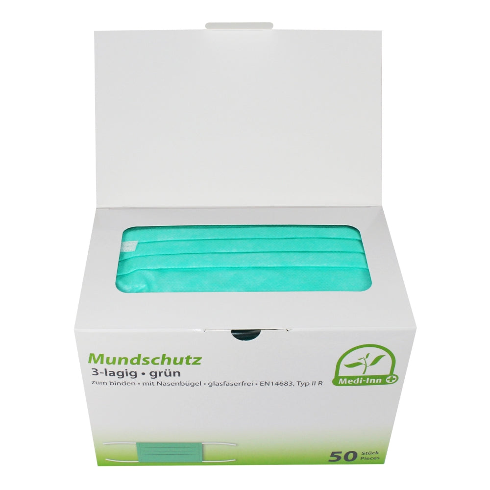 Ein medizinischer Mundschutz zum Binden, Typ IIR, ist auf dem Bild abgebildet. Der Mundschutz hat drei Schichten, die eine hohe Filtereffizienz und Schutz bieten. Er ist in einem sanften Blau gehalten, mit weich strukturiertem Material, das für Komfort sorgt. Der Mundschutz ist so gestaltet, dass er eng am Gesicht anliegt, um eine optimale Abdichtung zu gewährleisten. An den Enden sind Bänder zu sehen, die zum Binden hinter dem Kopf bestimmt sind.