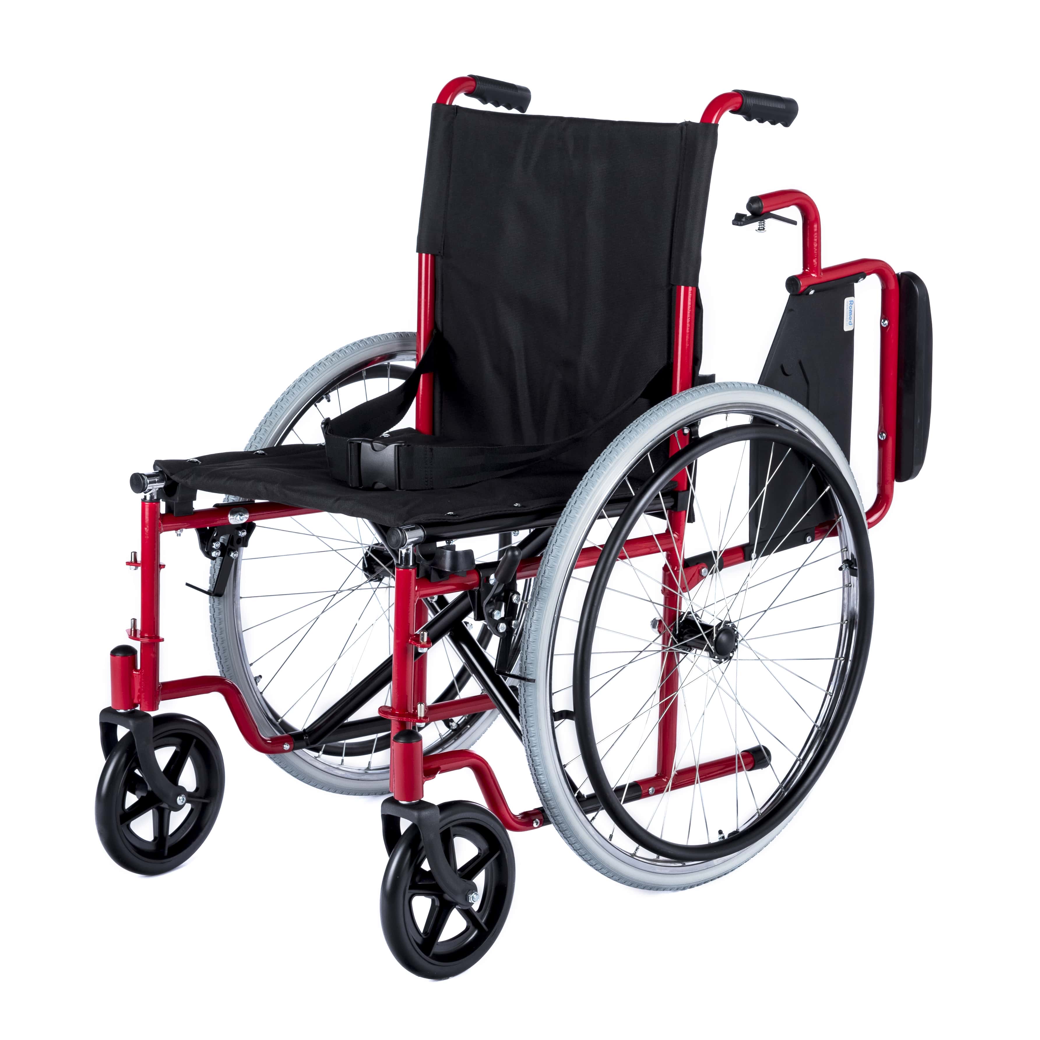 Manueller Rollstuhl "Romed Dynamic" mit einer Sitzbreite von 46 cm. Der Rollstuhl zeigt eine klappbare, robuste Bauweise mit einem stabilen Rahmen in Schwarz. Die Armlehnen sind gepolstert und der Sitz sowie die Rückenlehne sind mit einem strapazierfähigen, atmungsaktiven Stoff bezogen. Die großen Hinterräder und kleineren Vorderrollen ermöglichen eine einfache Manövrierbarkeit. Sichtbare Fußstützen sind abnehmbar, was den Zugang erleichtert.