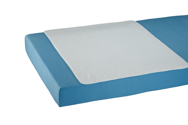 Weißes Bettauflagen-Produkt auf einem hellen Hintergrund. Die Auflage hat eine rechteckige Form mit den Maßen 85 cm x 90 cm. Ihre Oberfläche wirkt weich und hochwertig, während die Kanten ordnungsgemäß genäht sind. Auf der Oberseite sind keine zusätzlichen Muster oder Designs zu erkennen, was für ein schlichtes, elegantes Erscheinungsbild sorgt. Die Bettauflage ist ideal für den Schutz und den Komfort von Betten und kann für verschiedene Einrichtungsstile verwendet werden.