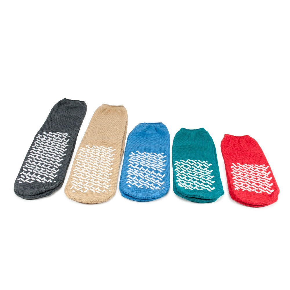 Fünf farbige Medi-Inn Anti-Rutsch-Socken in Schwarz, Beige, Blau, Grün und Rot mit rutschhemmendem Profil, nebeneinander angeordnet.